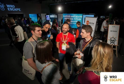 A group of people talk during WroEscape 2017