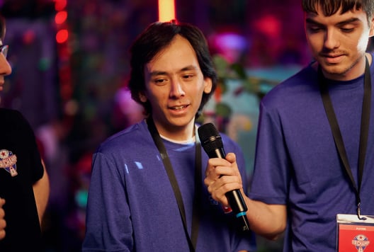 One of the players is giving an interview and speaking into a microphone after the games.