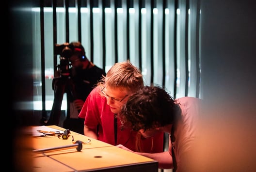 Players solving The Cube's puzzles during the finals