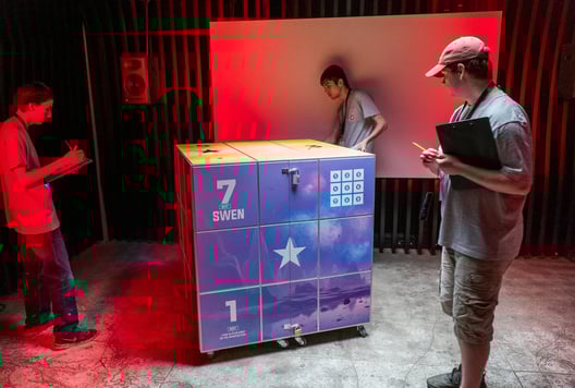 Players solving The Cube's puzzles during the finals